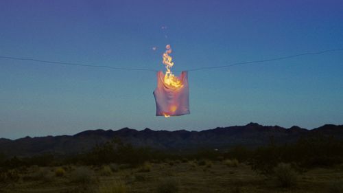 A shirt on a clothesline caught on fire