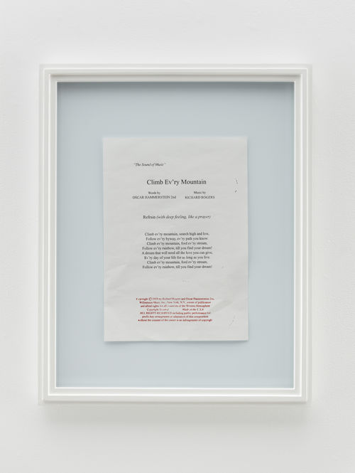 a framed piece of paper writing