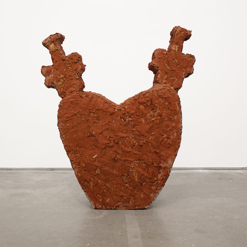 a cement sculpture in the shape of a heart 