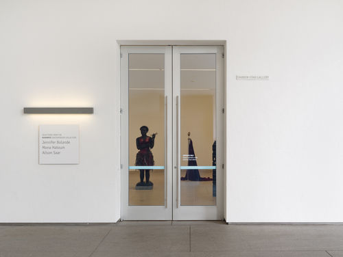 exterior of gallery with sculptural works viewable through glass doors