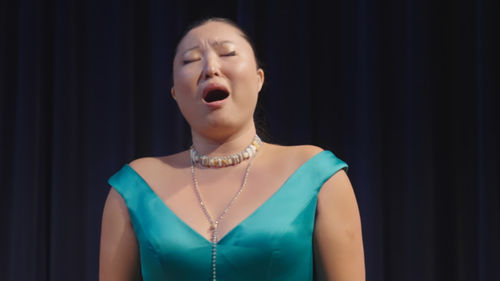 An opera singer with her mouth open