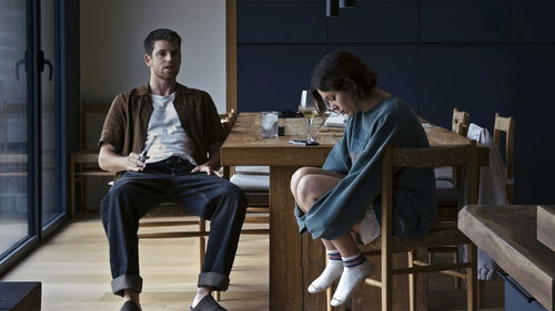 A man and woman sitting at a dining table
