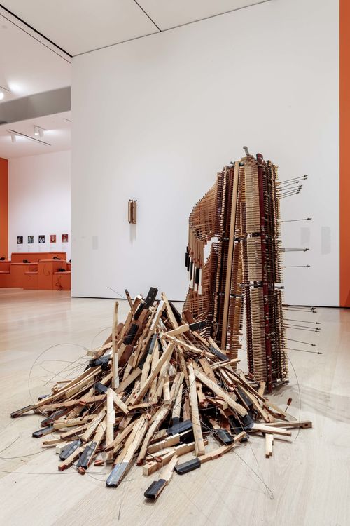 Installation view of a piano that has been disassembled and turned into an abstract sculpture