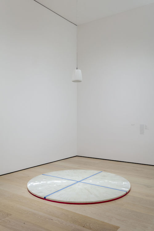 Installation view of a circular sculpture on the gallery floor