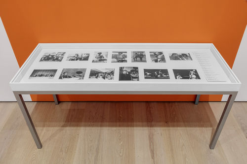 Installation view of a vitrine full of black-and-white photos