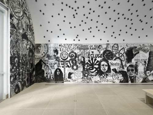 Vault installation featuring a floor-to-ceiling ceramic mural with black-and-white graphics, text, and images of people