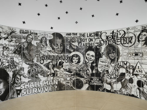 Vault installation featuring a floor-to-ceiling ceramic mural with black-and-white graphics, text, and images of people
