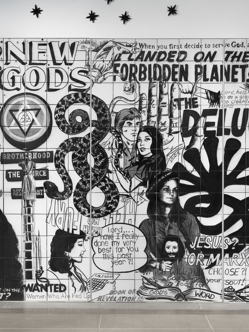 Vault installation featuring a floor-to-ceiling ceramic mural with black-and-white graphics, text, and images of people