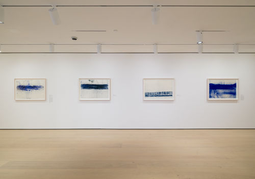 Gallery with framed works on paper on the wall