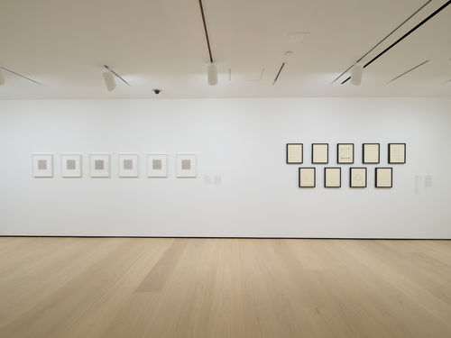 Gallery with framed works on paper on the wall