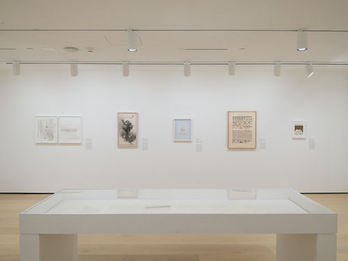 Gallery with framed works on paper on the wall