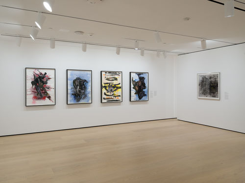 Gallery with framed works on paper on the wall