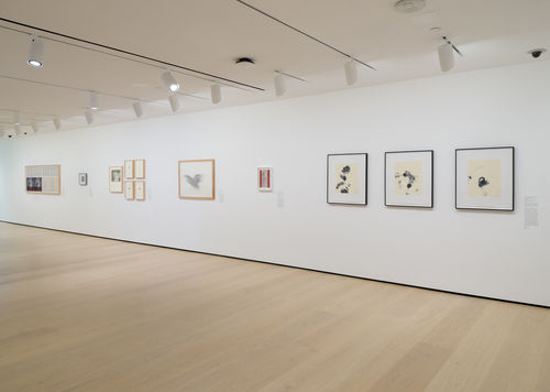 Gallery with framed works on paper on the wall