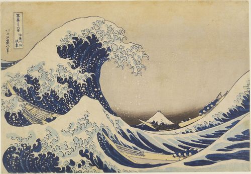 A large wave crests above two large boats, a small snow-topped mountain in the background