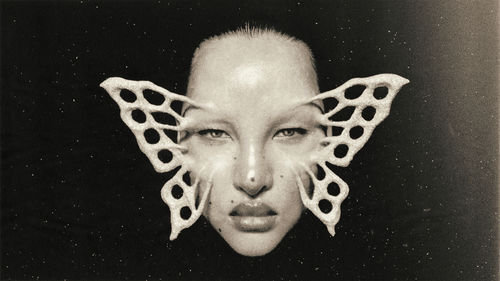 A white face with a white butterfly superimposed over it