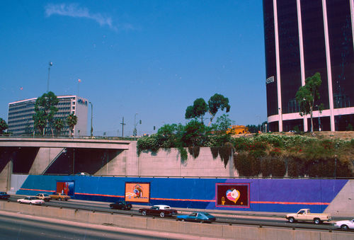 Archival image of a large-scale mural painted on the side of a freeway