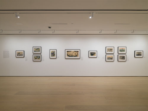Gallery with framed works on paper installed on walls