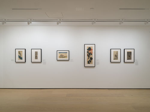 Gallery with framed works on paper installed on walls