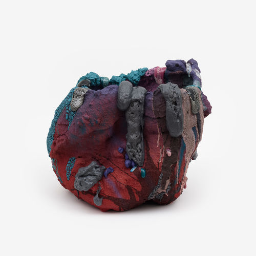 Abstract sculpture in reds, blues, browns, black, and grays