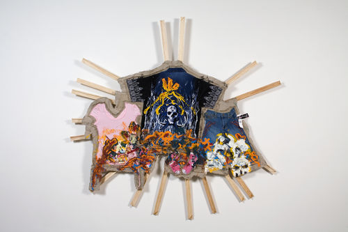 Multicolored material hanging on approx. 16 wood bars