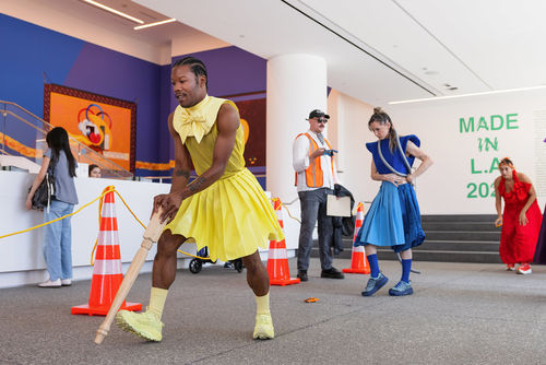 Brightly dressed dancers in the lobby of the Hammer Museum