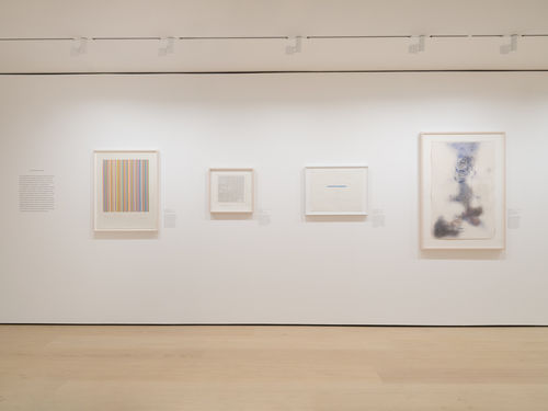 Gallery with framed works on paper on the wall