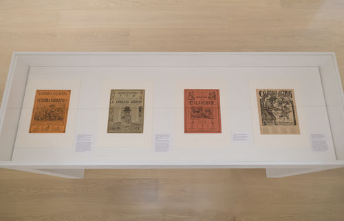 Four works by José Guadalupe Posada in a vitrine