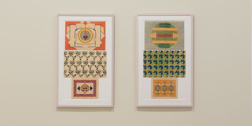 Two framed artworks on a wall with colorful geometric patterns