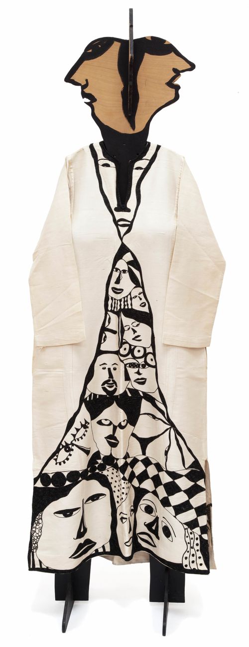 Mannequin wearing a caftan decorated with painted faces