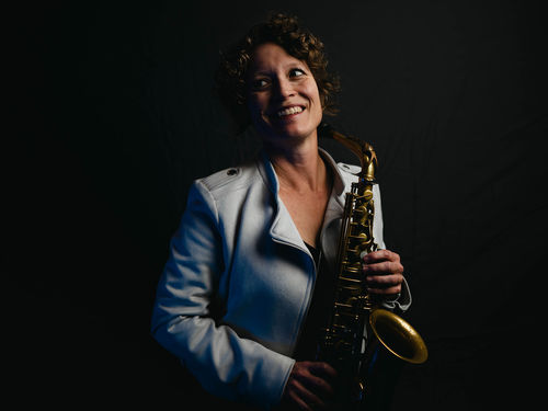 Kasey Knudsen holding a saxophone