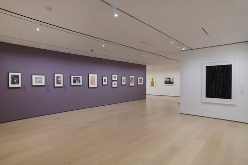 Gallery with framed works on paper mounted on the wall