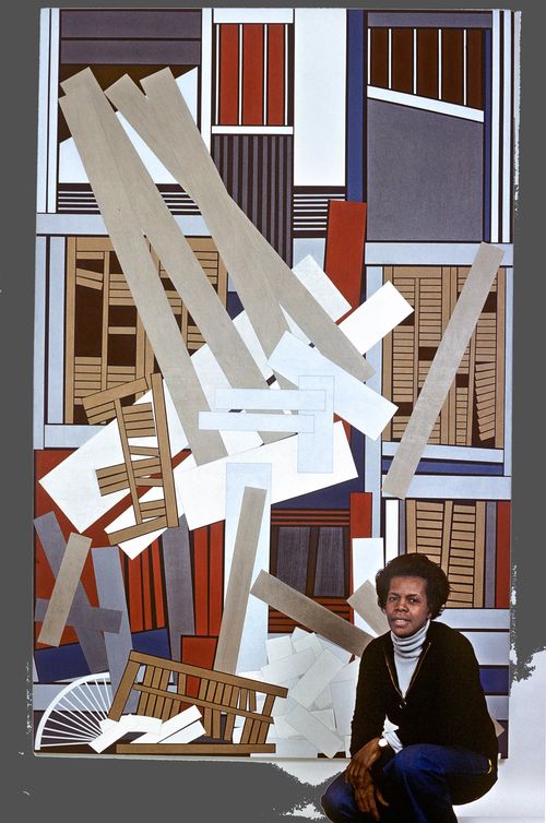 Artist Mavis Pusey crouches in front of a large vertical painting