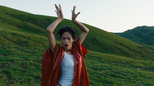 A figure dancing on a hillside 