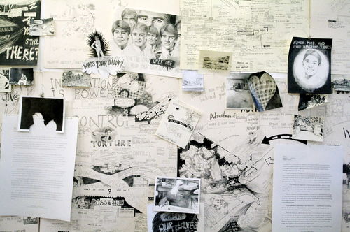 Graphite drawings cover a gallery wall