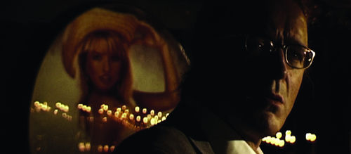 Close up of a man in glasses, his face mostly in shade