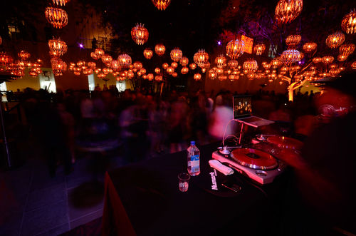 Guests in courtyard during the opening of "Now Dig This!," DJ spinning in foreground. Hammer Museum, Los Angeles