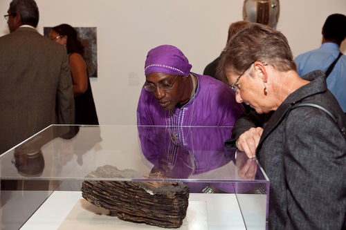 Guests look at Noah Purifoy, "Watts Uprising Remains," c. 1965–66 during the opening of "Now Dig This!" Hammer Museum, Los Angeles