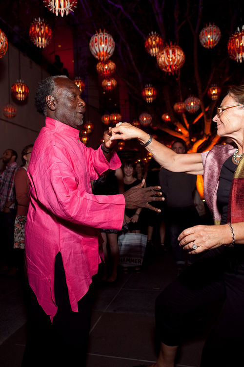 Artist Raymond Saunders (left) dances with a guest at the opening of "Now Dig This!" Hammer Museum, Los Angeles, CA