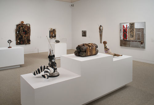 Foreground: three works by John Outterbridge, from left to right: "Case in Point," from the Rag Man Series, c. 1970, "Untitled," c. 1974–76, and "Captive Image #4," from the Ethnic Heritage Group, c. 1974–76; right wall: multiple works by John Outterbridge; left wall: multiple assemblages by Noah Purifoy and John T. Riddle Jr. Installation view at the Hammer Museum, Los Angeles