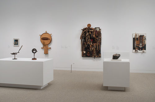 Back wall: four works by Noah Purifoy, from left to right: "Pressure," c. 1966, "Untitled," 1970, "Untitled (Assemblage)," 1967, "Zulu #4," n.d.; foreground, from left to right: two works by John T. Riddle Jr., "Panthers," 1970s and "Untitled," c. 1970, Noah Purifoy, "Watts Uprising Remains," c. 1965–66. Installation view at the Hammer Museum, Los Angeles