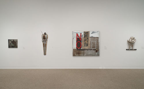 Four works by John Outterbridge, from left to right: "Eastside-Westside," from the Containment Series, c. 1970, "Urban Man," from the Ethnic Heritage Group, 1981, "No Time for Jivin'," from the Containment Series, 1969, and "Jive Ass Bird," from the Rag Man Series, 1971. Installation view at the Hammer Museum, Los Angeles