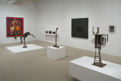 Standing: three works by John T. Riddle Jr., from left to right: "Gradual Troop Withdrawal," 1970, "Untitled (Fist)," c. 1965, and "Ghetto Merchant," 1966; left wall: Alonzo Davis, "Self-Portrait Inside Series," 1975; right wall, from left to right: vitrine with three works by Daniel LaRue Johnson, Daniel LaRue Johnson, "Freedom Now, Number 1," 1963–64, and Noah Purifoy, "Pressure," c. 1966. Installation view at the Hammer Museum, Los Angeles