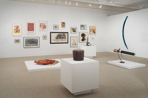 Foreground: Houston Conwill, "Drum," c. 1975–80; standing behind, from left to right: Dan Concholar, "Suitcase," c. 1980, John T. Riddle Jr., "America's Problem Solver," 1970s; right wall: Fred Eversley, "Untitled," 1984; background: works by Sister Karen Boccalero, Elizabeth Leigh-Taylor, Suzanne Jackson, and others. Installation view at the Hammer Museum, Los Angeles