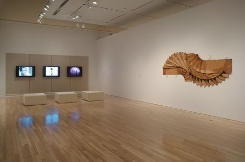 Left wall: three videos by Ulysses Jenkins; right wall: David Hammons, "Bag Lady in Flight," 1970s. Installation view at the Hammer Museum, Los Angeles