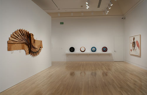 Left wall: David Hammons, "Bag Lady in Flight," 1970s; back wall: four works by Fred Eversley, "Untitled," 1976, "Untitled," 1973, "Untitled," 1973, and "Untitled," 1978; right wall: Suzanne Jackson, "Apparitional Visitations," 1973. Installation view at the Hammer Museum, Los Angeles