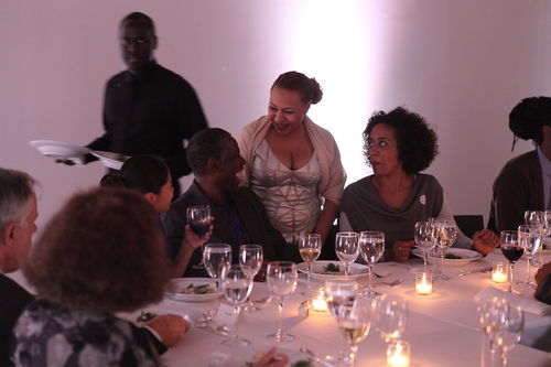Curator Kellie Jones (standing) speaks to artist Charles Gaines at the dinner reception honoring "Now Dig This!" MoMA PS1, Long Island City, NY