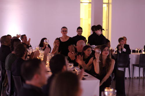 Artist Maren Hassinger (standing, center) receives applause at the dinner reception honoring "Now Dig This!" MoMA PS1, Long Island City, NY