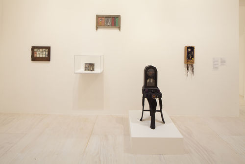 Foreground: Betye Saar, "Indigo Mercy," 1975; background: works by Betye Saar, from left to right: "Mystic Window for Leo," 1966, "Imitation of Life," 1975, "Let Me Entertain You," 1972, and "Gris-Gris Box," 1972. Installation view at MoMA PS1, Long Island City, NY