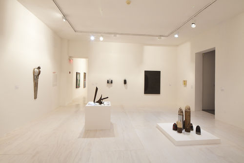Foreground: Mark di Suvero, "Untitled," c. 1965 and Dale Brockman Davis, "Viet Nam War Games," 1969; background: works by John Outterbridge, Ron Miyashiro, Virginia Jaramillo, and Sheila Levrant de Bretteville. Installation view at MoMA PS1, Long Island City, NY