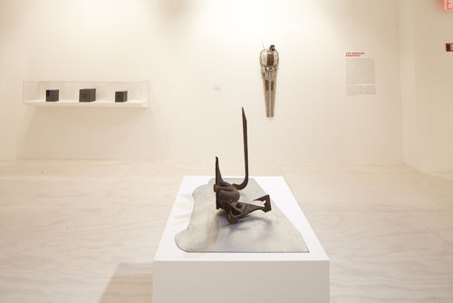 Foreground: Mark di Suvero, "Untitled," c. 1965; background: vitrine with three works by Daniel LaRue Johnson, John Outterbridge, "Urban Man," from the Ethnic Heritage Group, 1981. Installation view at MoMA PS1, Long Island City, NY